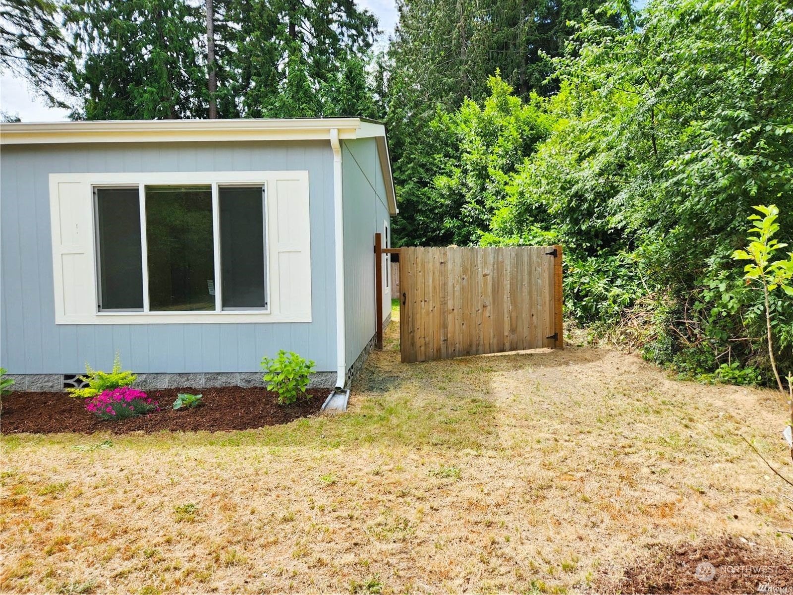 2681 Northeast John Carlson Road Bremerton, WA 98311 - Photo 2 of 15 a house with trees in front of it