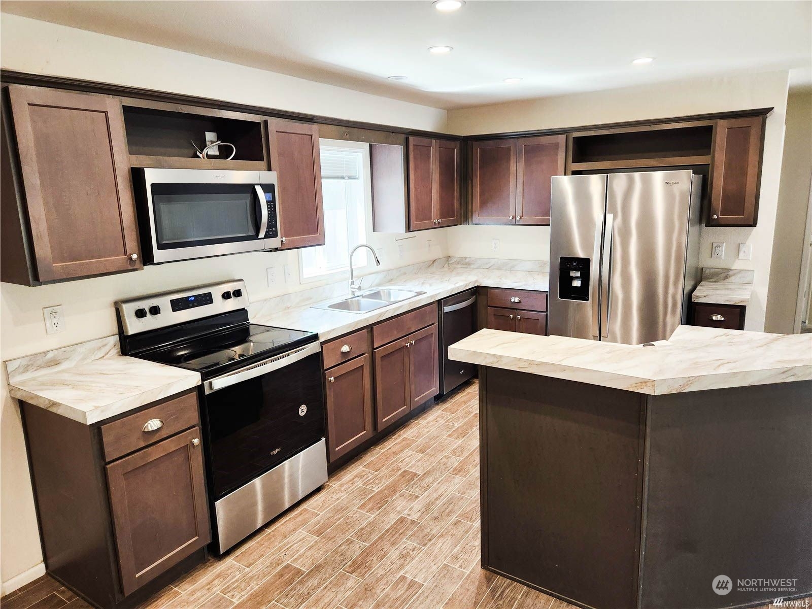 2681 Northeast John Carlson Road Bremerton, WA 98311 - Photo 5 of 15 a kitchen with stainless steel appliances granite countertop a stove a sink and a microwave