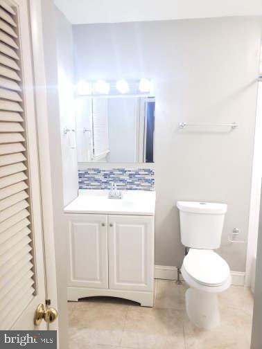 1 Walton Road Mount Holly, NJ 08060 - Photo 21 of 46 a bathroom with a granite countertop toilet a sink and a mirror
