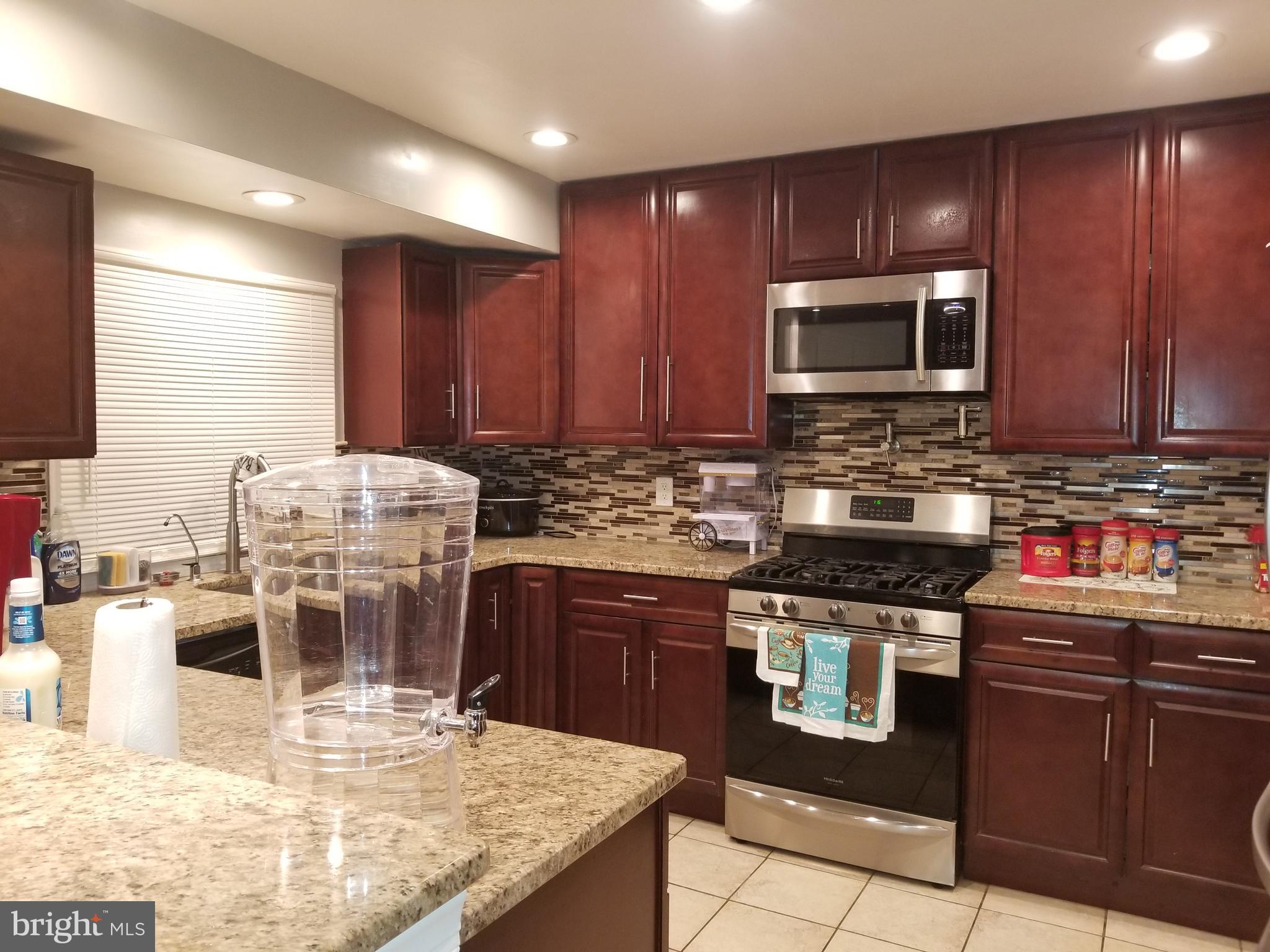 1 Walton Road Mount Holly, NJ 08060 - Photo 29 of 46 a kitchen with stainless steel appliances granite countertop a stove sink microwave and cabinets