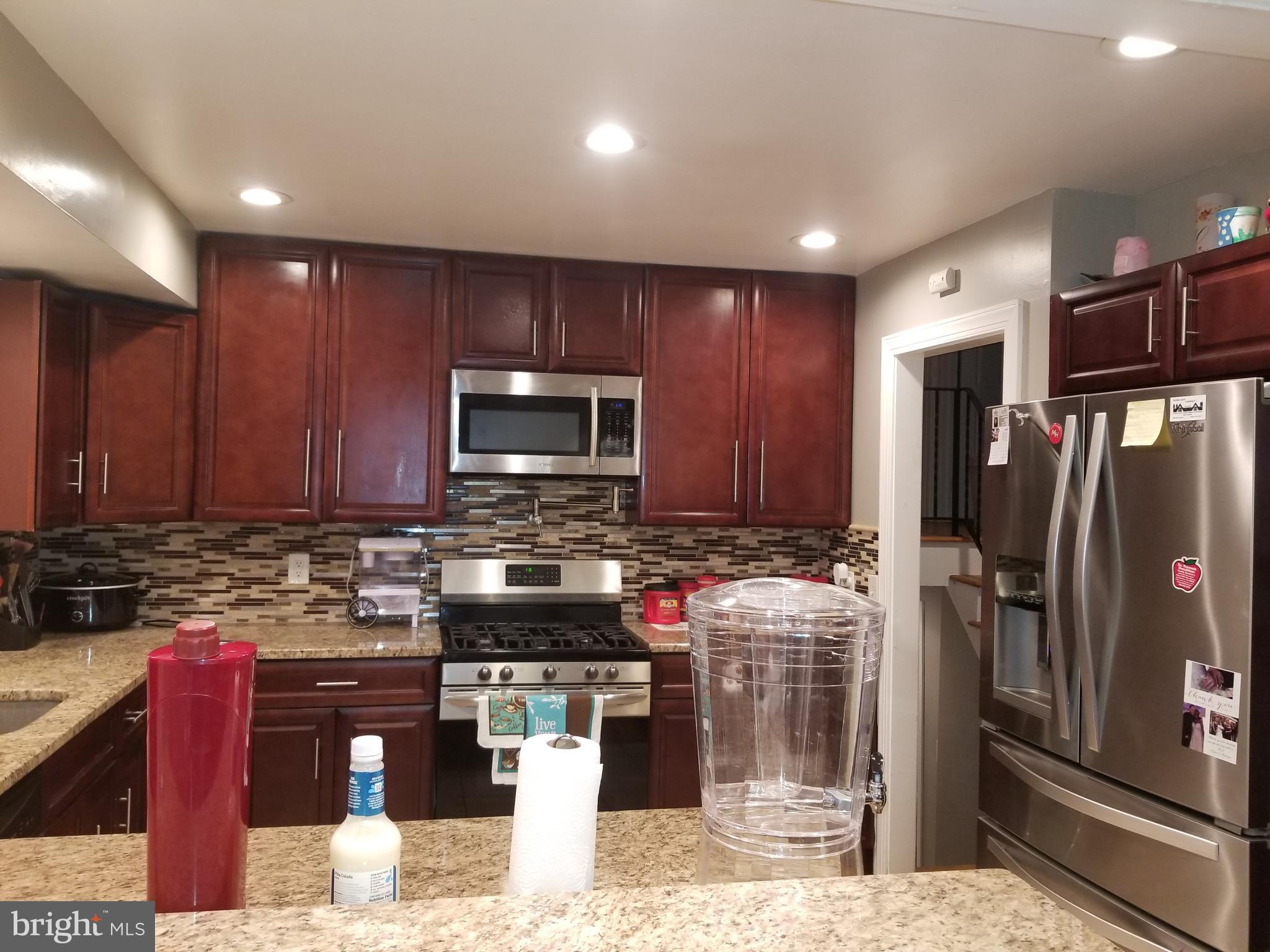 1 Walton Road Mount Holly, NJ 08060 - Photo 31 of 46 a kitchen with stainless steel appliances wooden cabinets a stove a sink and a refrigerator