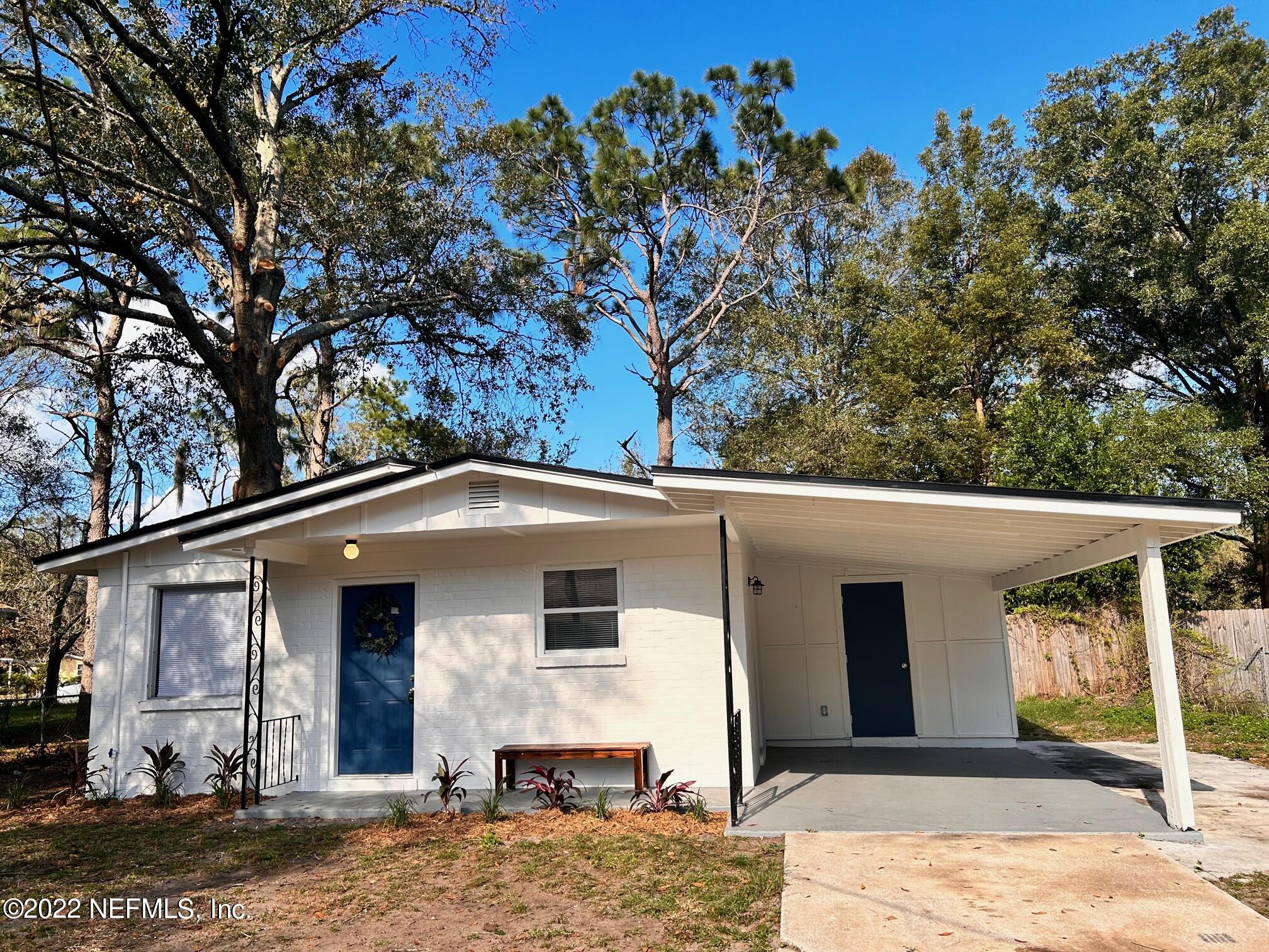 7269 Melvin Road Jacksonville, FL 32210 - Photo 3 of 11 a front view of a house with garden