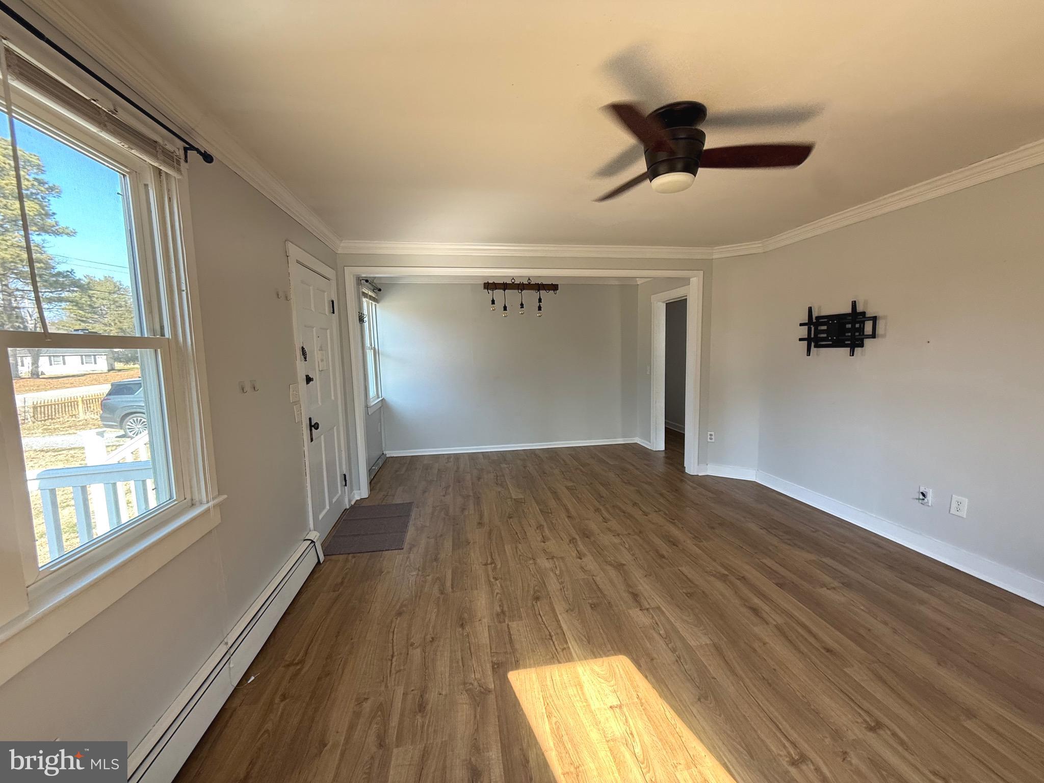 23055 Old Fairlee Road Chestertown, MD 21620 - Photo 11 of 26 a view of empty room with wooden floor and fan