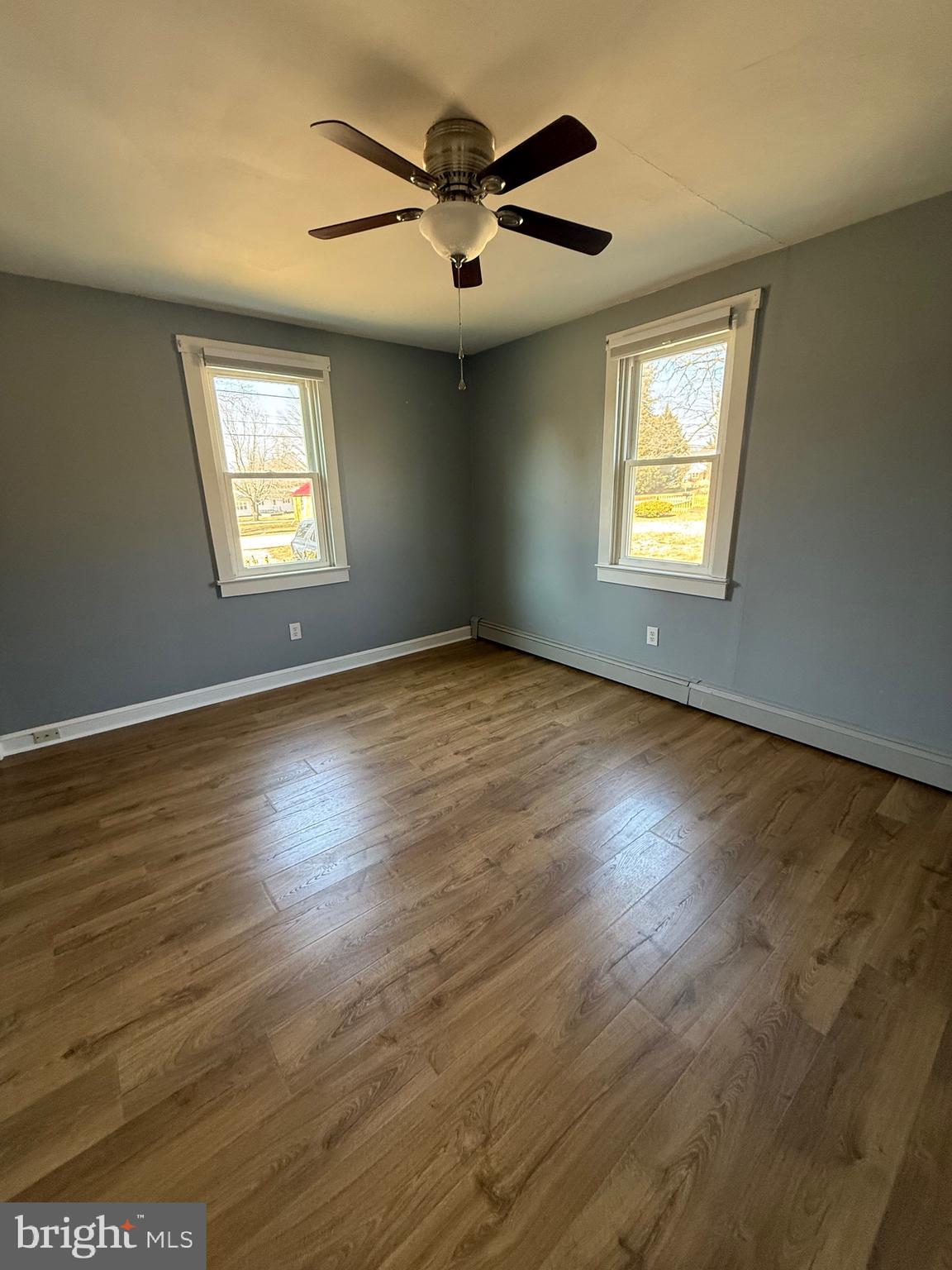 23055 Old Fairlee Road Chestertown, MD 21620 - Photo 12 of 26 an empty room with wooden floor and windows