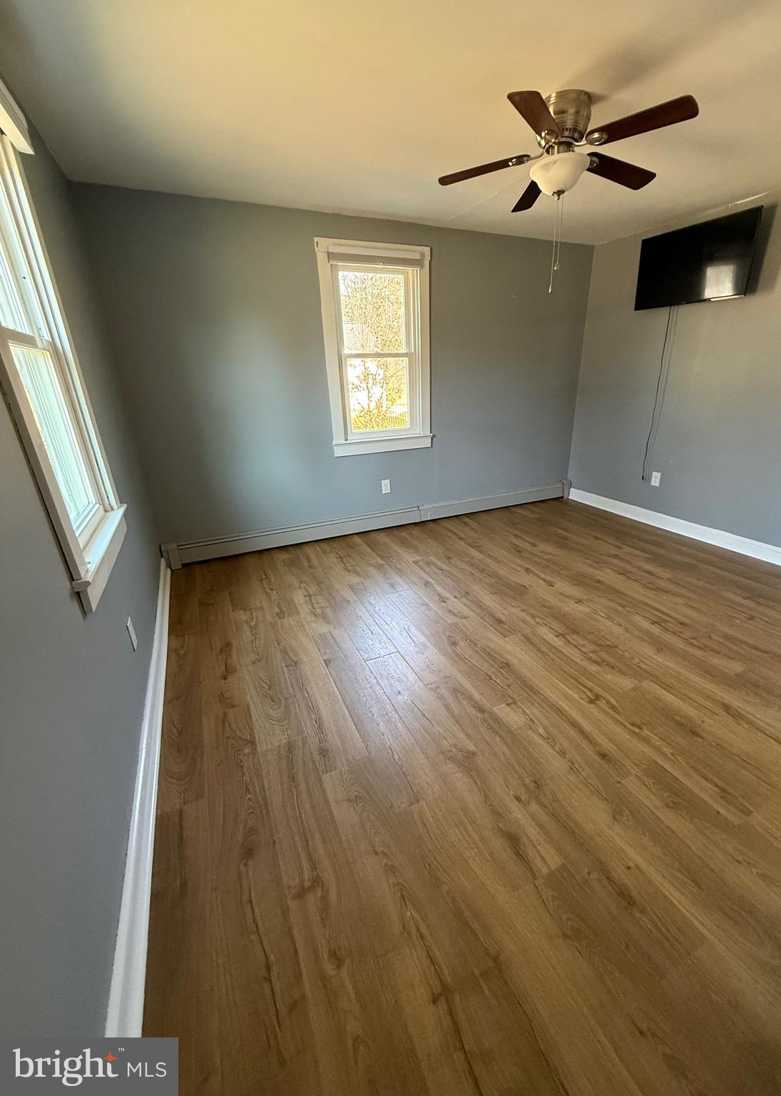 23055 Old Fairlee Road Chestertown, MD 21620 - Photo 13 of 26 wooden floor in an empty room with a window