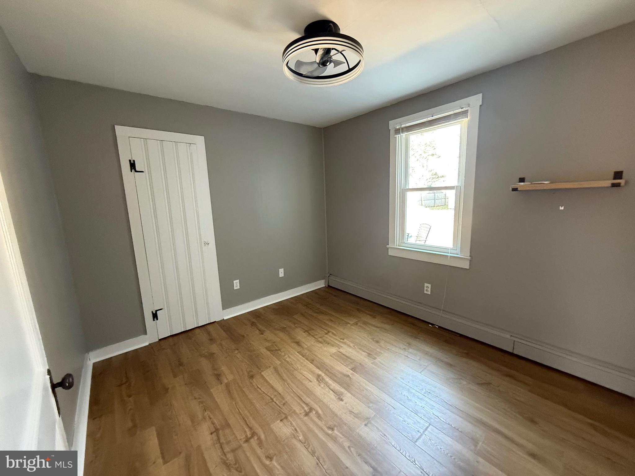 23055 Old Fairlee Road Chestertown, MD 21620 - Photo 17 of 26 an empty room with a window and hardwood floor