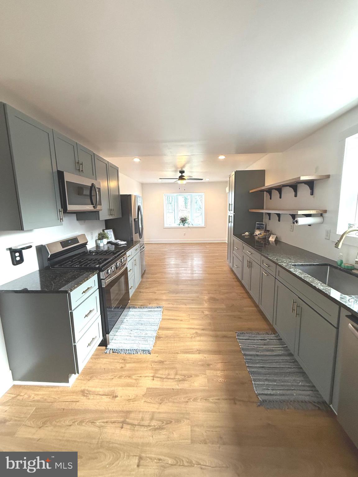 23055 Old Fairlee Road Chestertown, MD 21620 - Photo 3 of 26 a large kitchen with kitchen island a sink dishwasher stove and oven with wooden floor