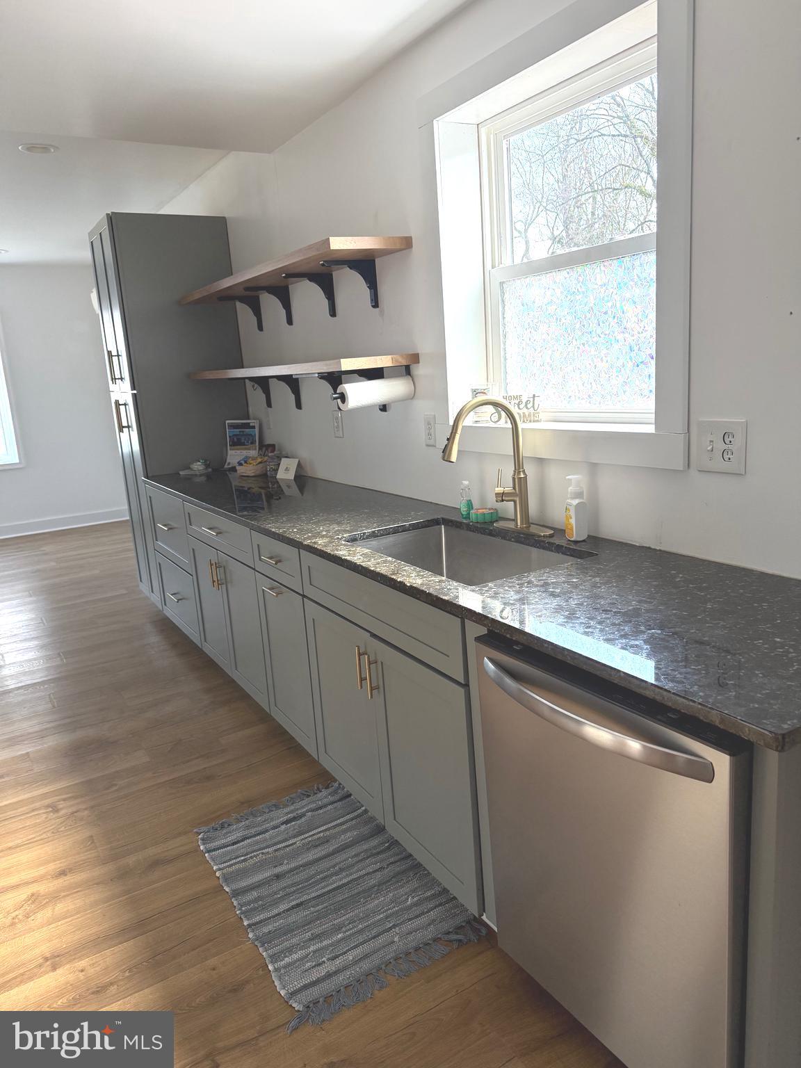 23055 Old Fairlee Road Chestertown, MD 21620 - Photo 6 of 26 a kitchen with stainless steel appliances granite countertop a stove a sink and a microwave