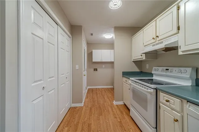 a kitchen with cabinets and appliances