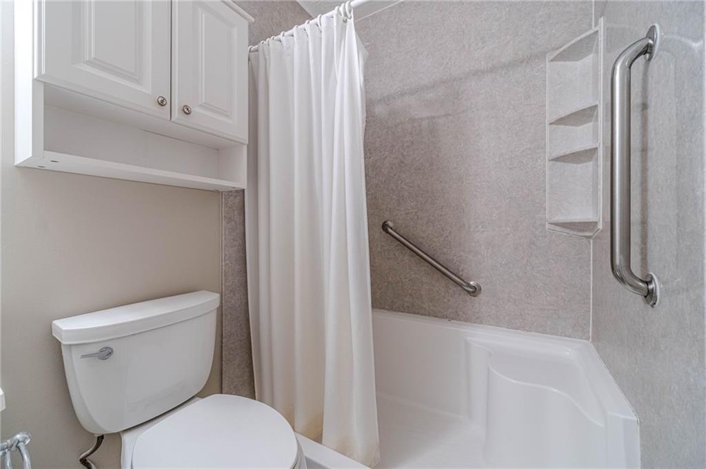 119 West Ash Street Social Circle, GA 30025 - Photo 26 of 44 a bathroom with a toilet and a shower