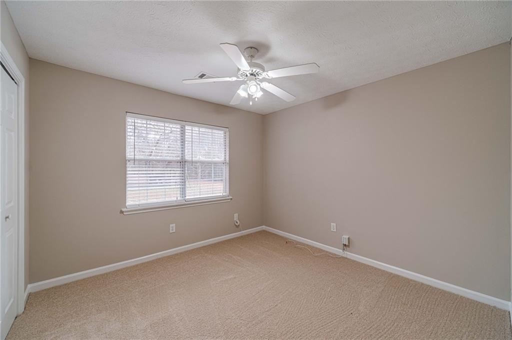119 West Ash Street Social Circle, GA 30025 - Photo 31 of 44 an empty room with a window and a fan