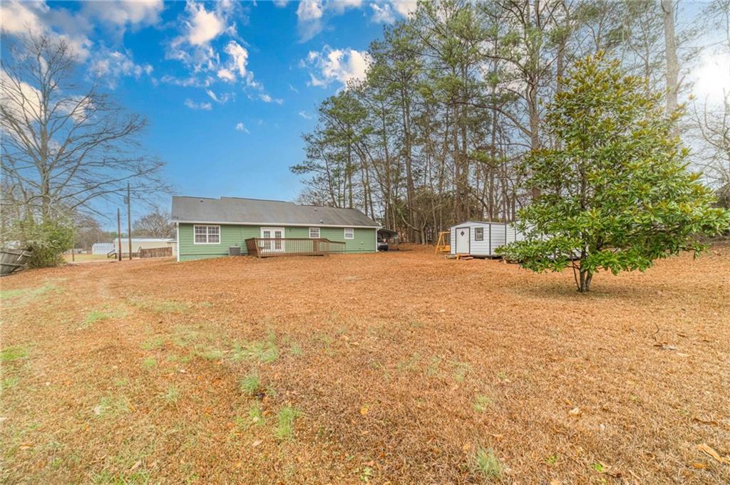 119 West Ash Street Social Circle, GA 30025 - Photo 38 of 44 a front view of a house with a yard and garage