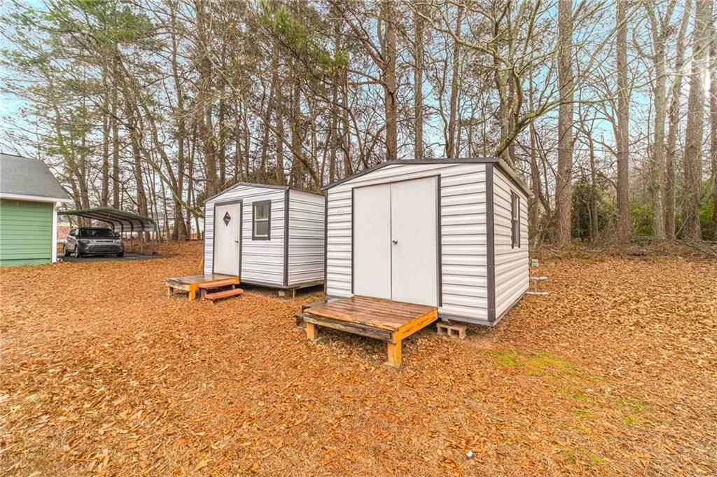 119 West Ash Street Social Circle, GA 30025 - Photo 39 of 44 a backyard of a house with barbeque oven and wooden fence
