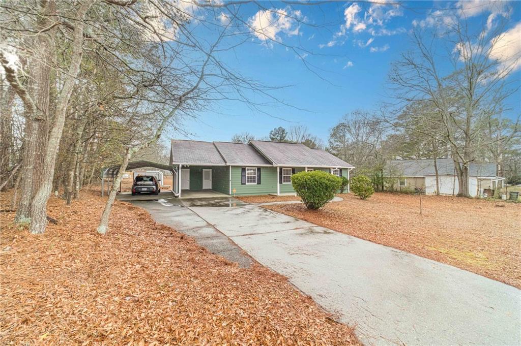 119 West Ash Street Social Circle, GA 30025 - Photo 42 of 44 a front view of a house with a yard covered in snow