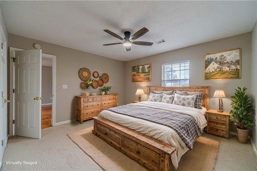 119 West Ash Street Social Circle, GA 30025 - Photo 5 of 44 a bedroom with a bed and a chandelier