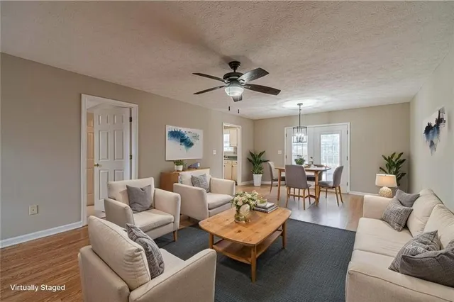 a living room with furniture a chandelier and a window