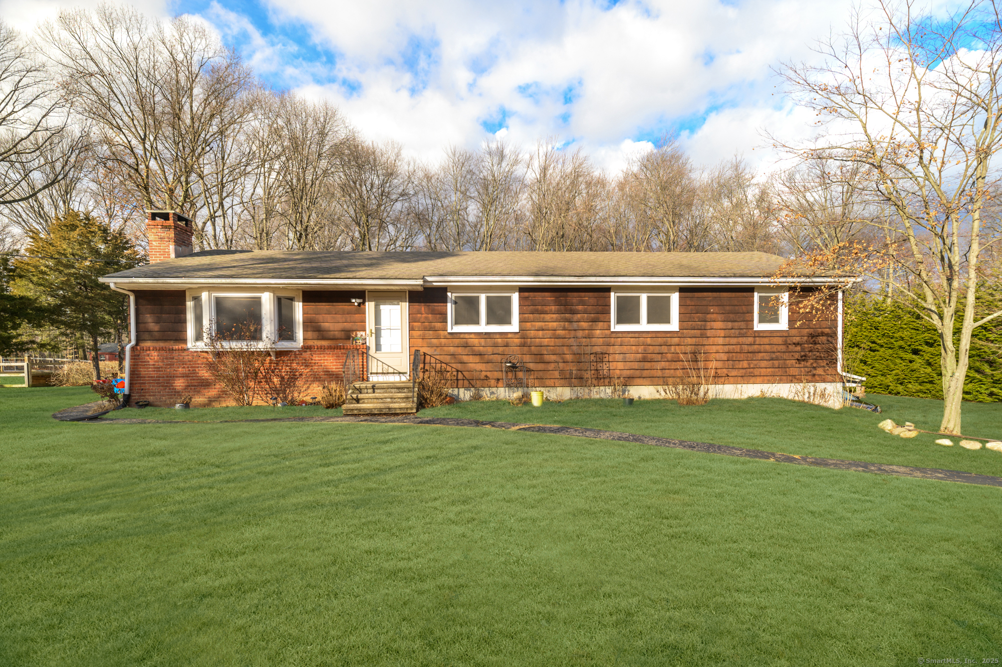 a view of a house with a backyard