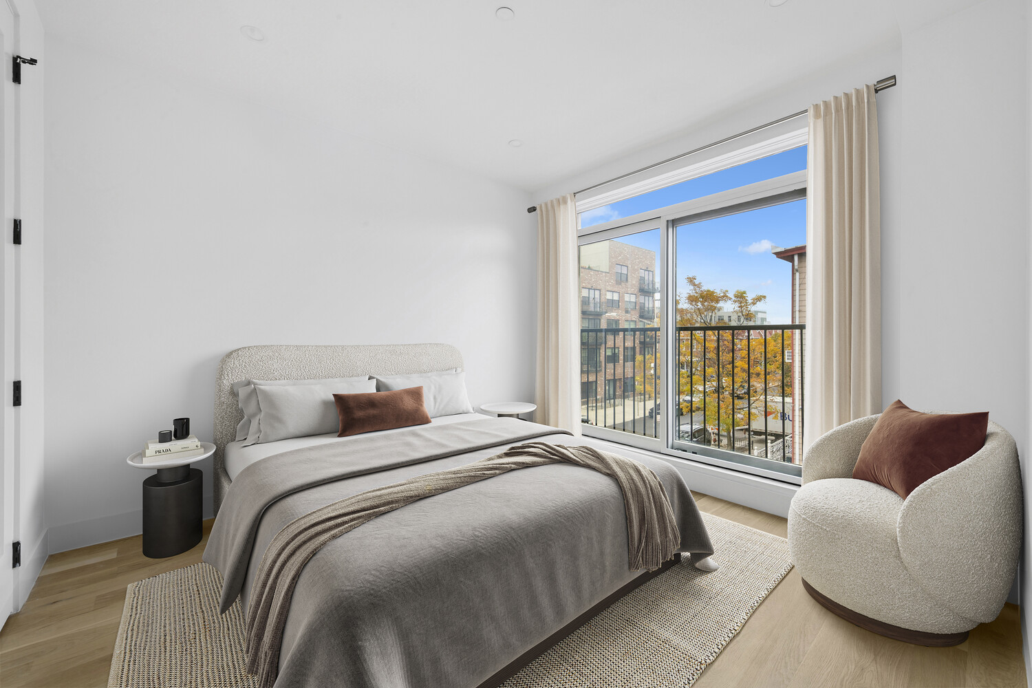 831 Knickerbocker Avenue, Unit 3B Brooklyn, NY 11207 - Photo 5 of 11 a bedroom with a bed and a couch next to a window