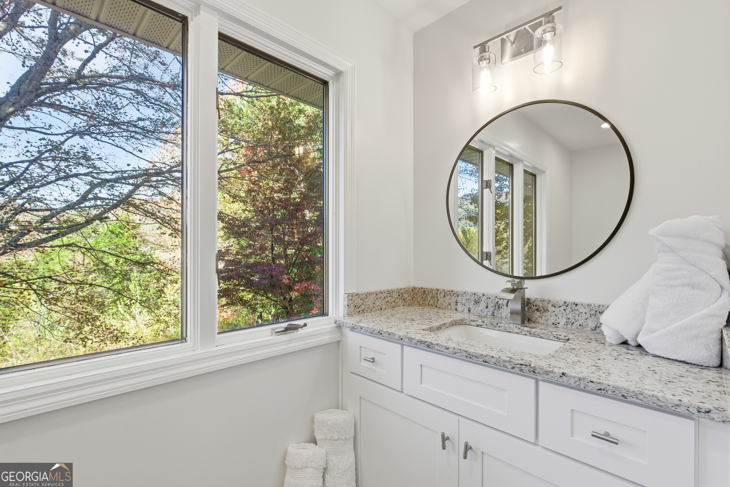 230 Majors Lane Rabun Gap, GA 30568 - Photo 11 of 54 a bathroom with a granite countertop sink and a mirror