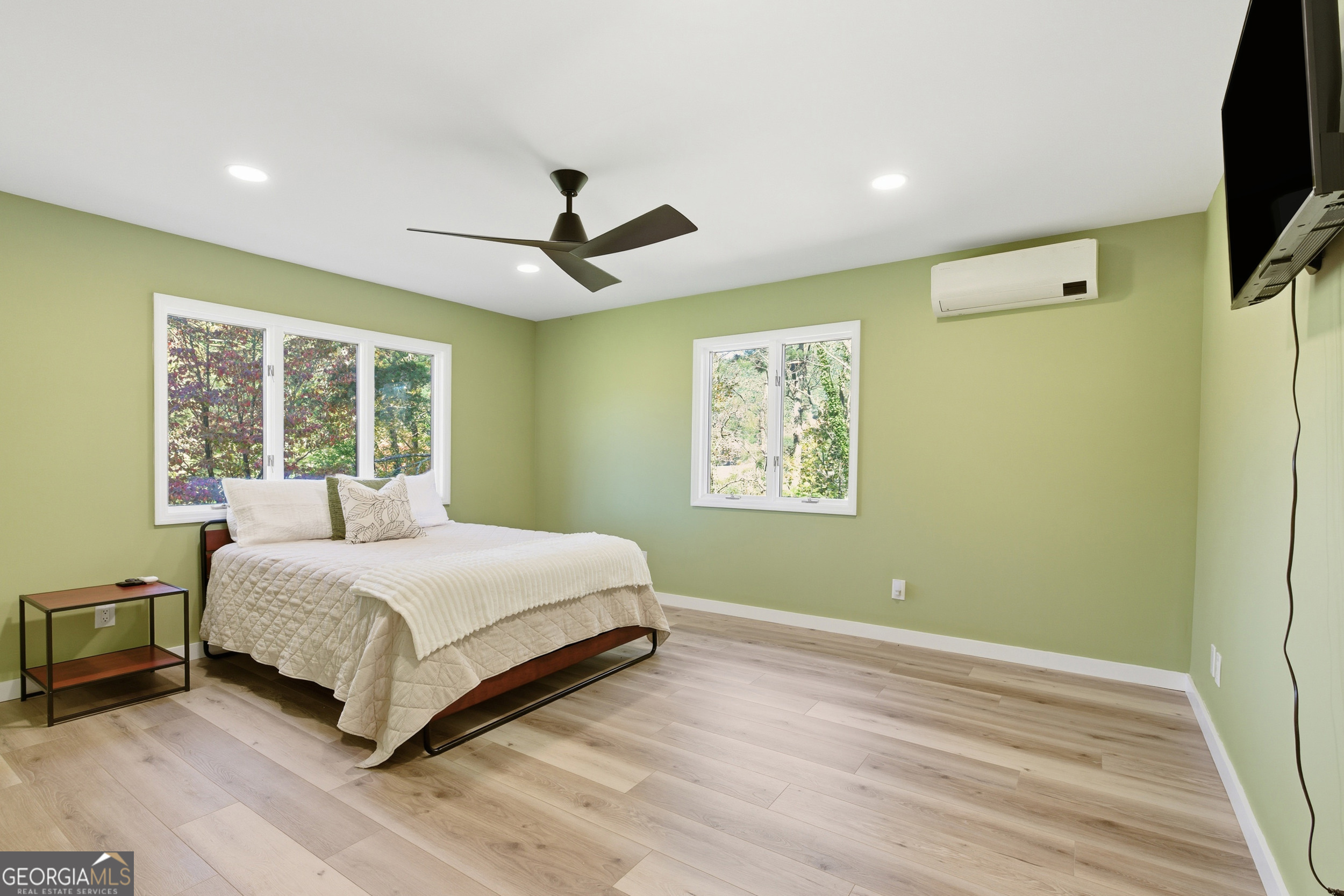 230 Majors Lane Rabun Gap, GA 30568 - Photo 12 of 54 a bedroom with a large bed and a flat tv screen on dresser