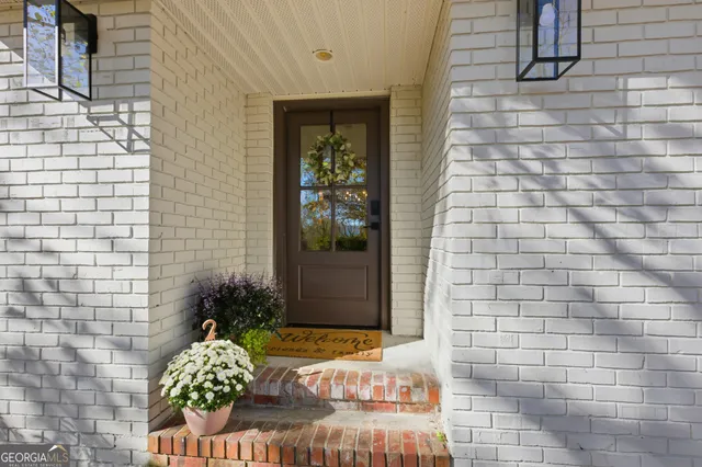 a view of a dining room with furniture a chandelier and wooden floor