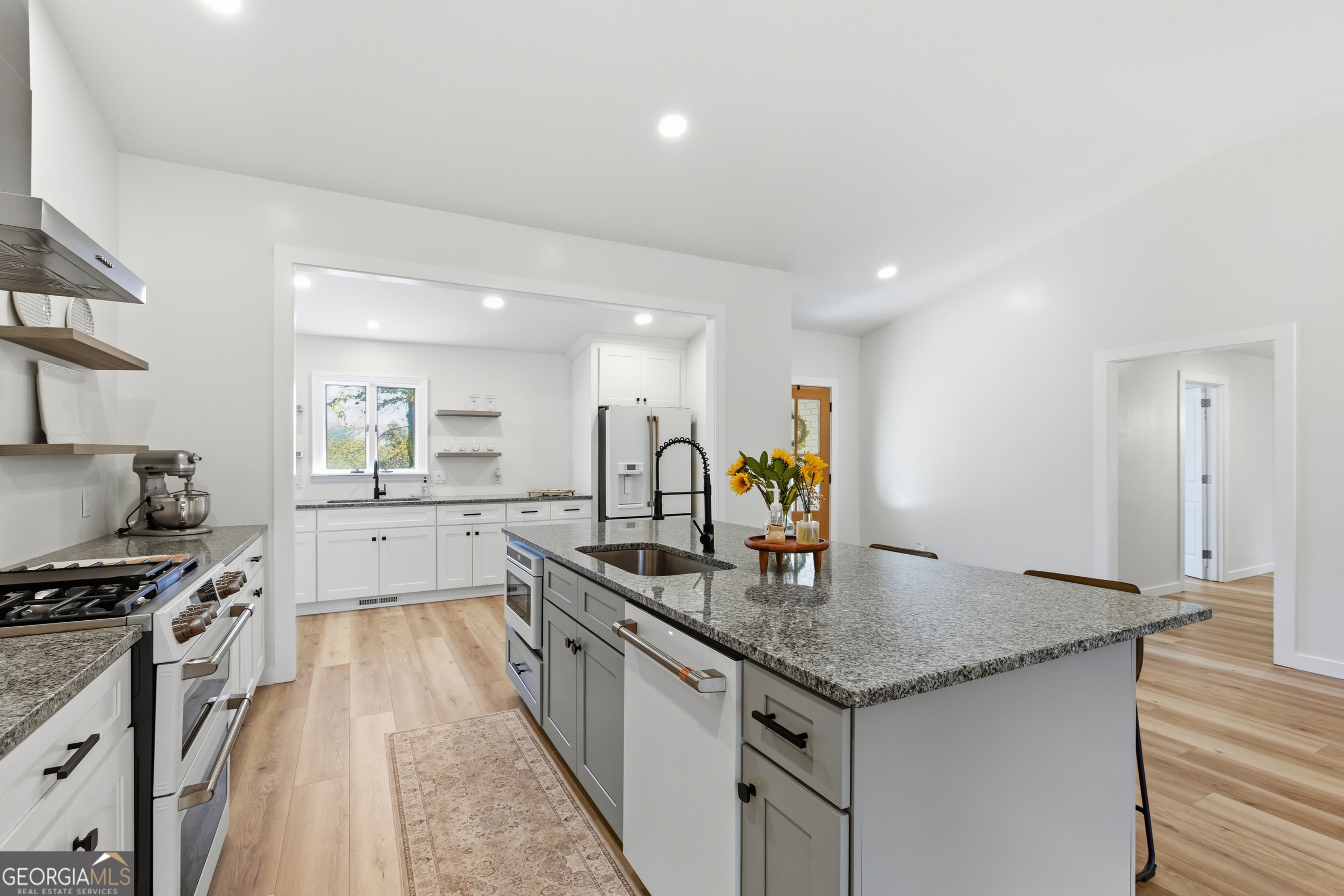 230 Majors Lane Rabun Gap, GA 30568 - Photo 23 of 54 a kitchen with stainless steel appliances granite countertop a sink a stove and a wooden floors
