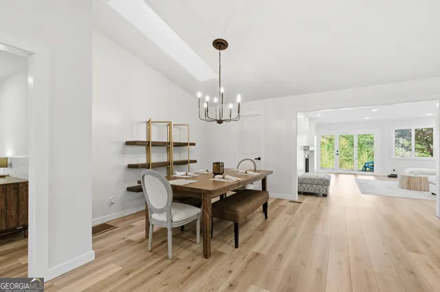 a view of a dining room with furniture wooden floor and chandelier