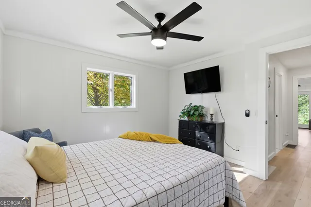 a room with round mirror and cabinets