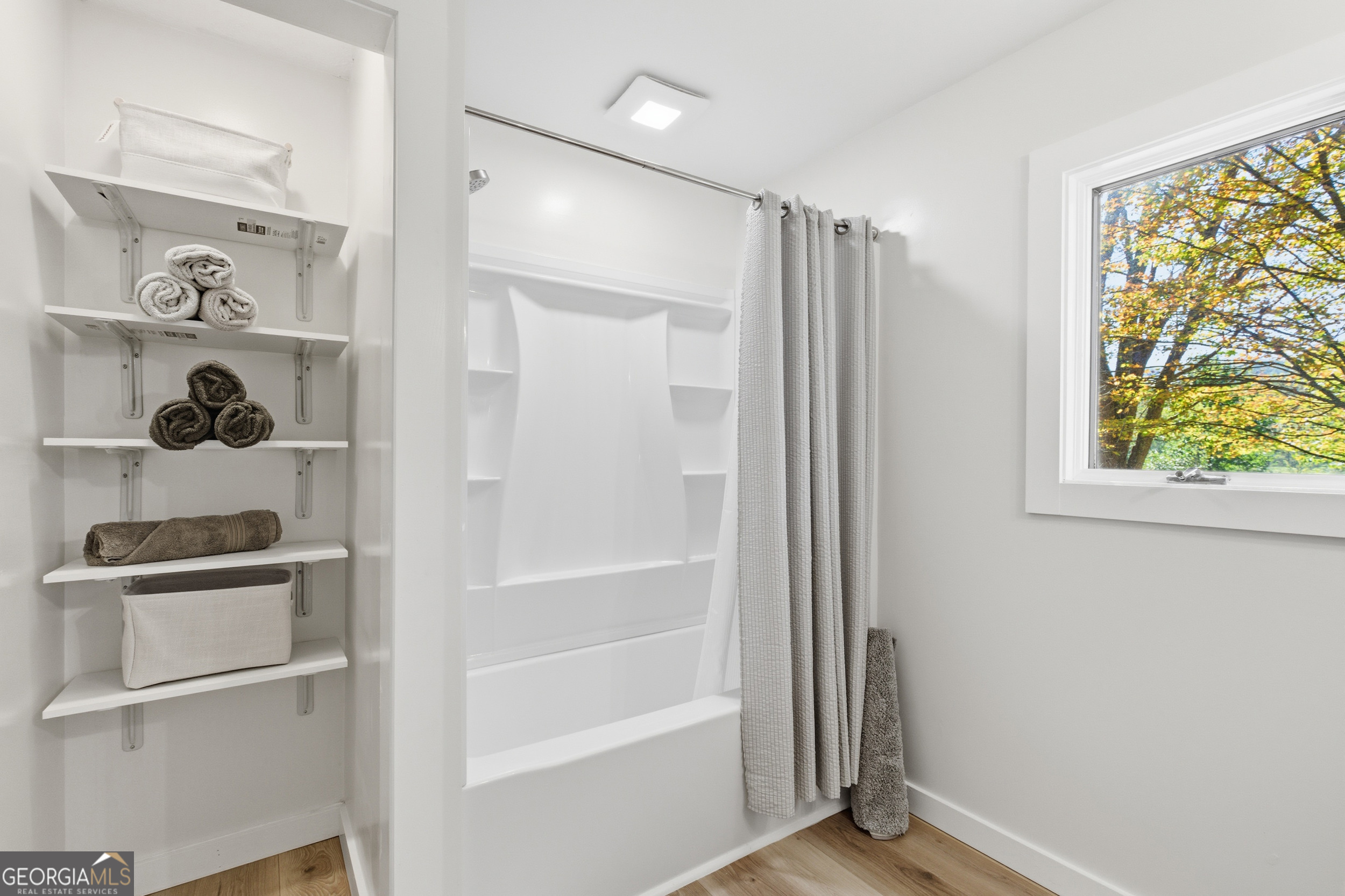 230 Majors Lane Rabun Gap, GA 30568 - Photo 34 of 54 a bathroom with a bathtub and a window