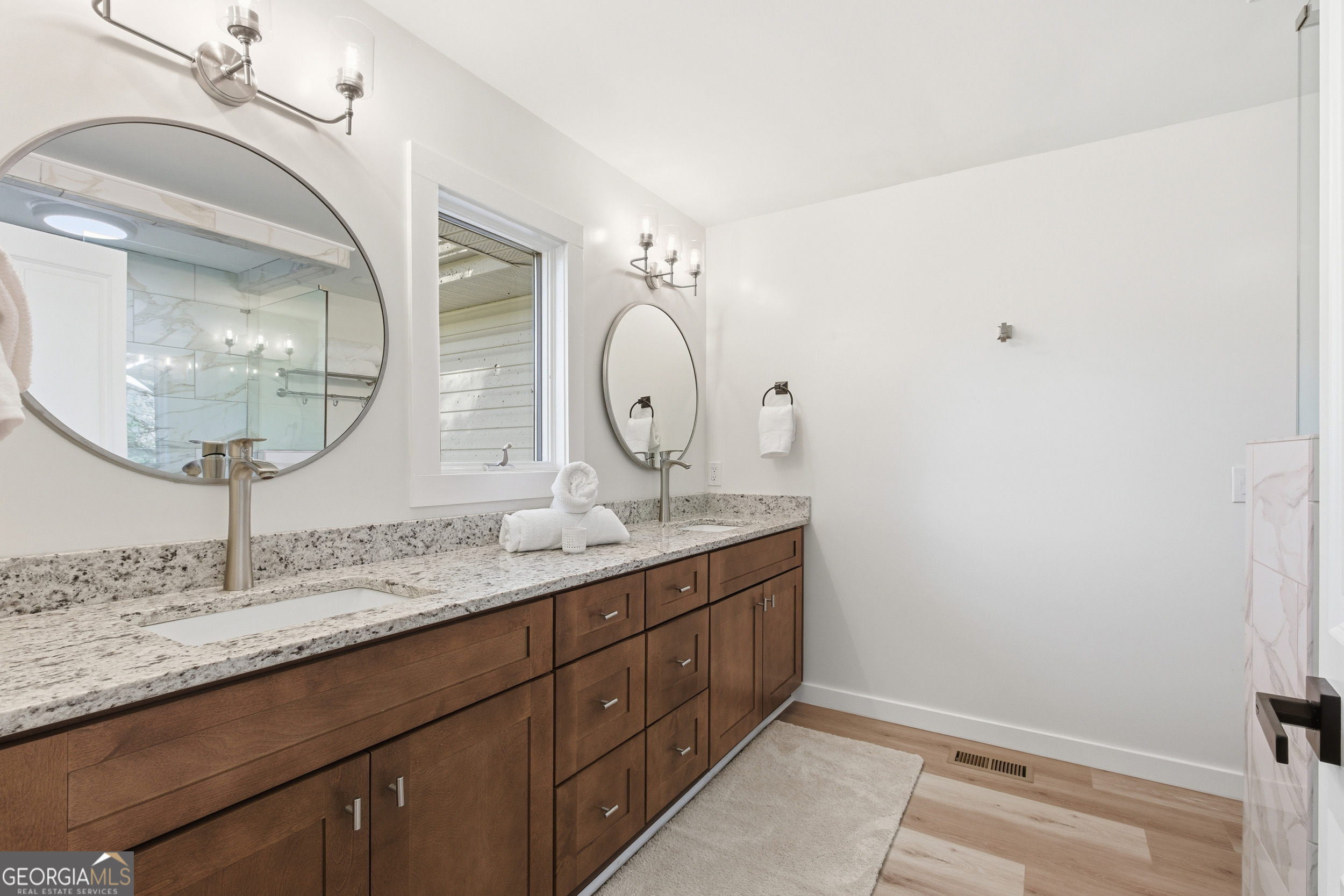 230 Majors Lane Rabun Gap, GA 30568 - Photo 35 of 54 a room with round mirror and cabinets