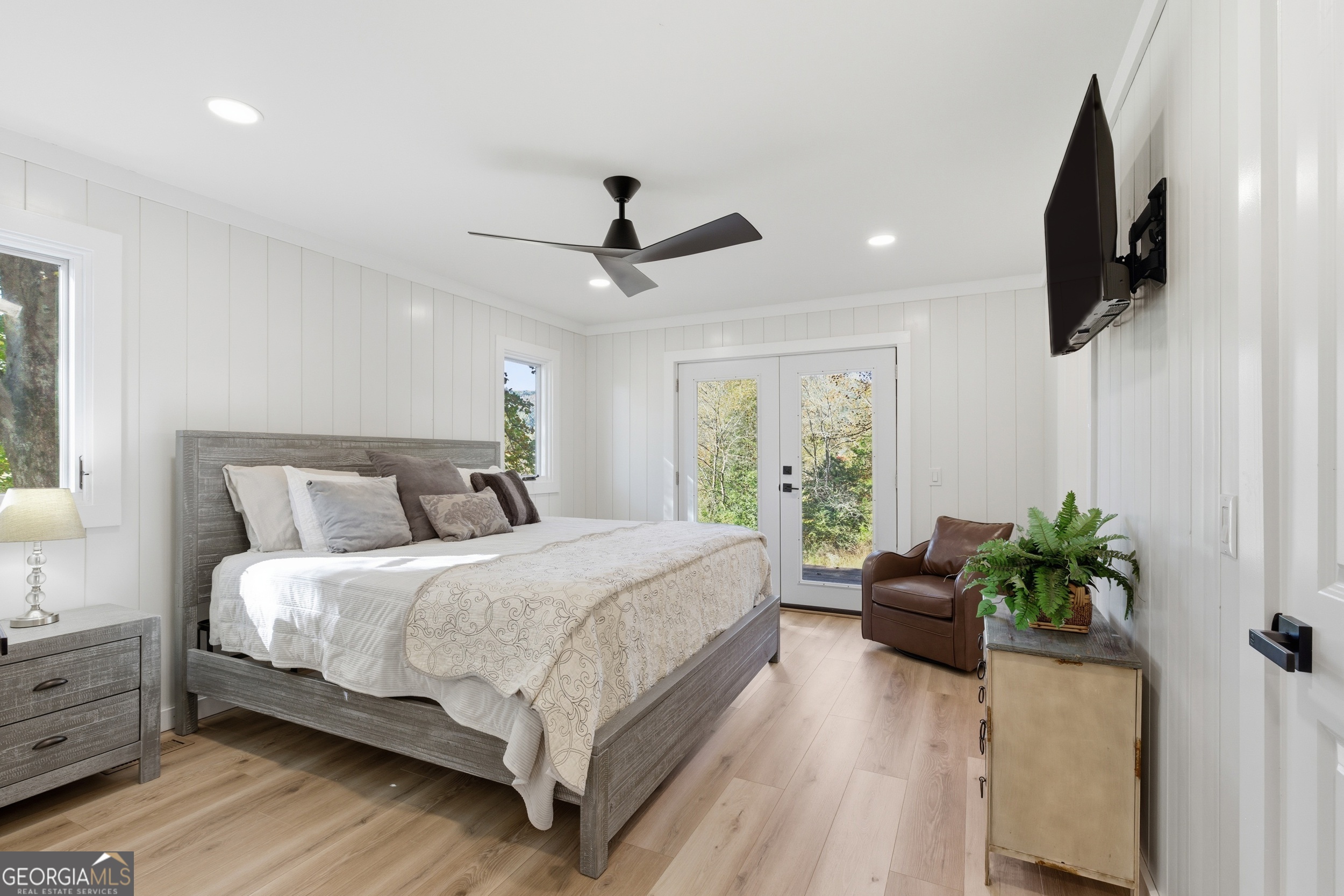 230 Majors Lane Rabun Gap, GA 30568 - Photo 4 of 54 a bedroom with a bed chandelier and a flat screen tv