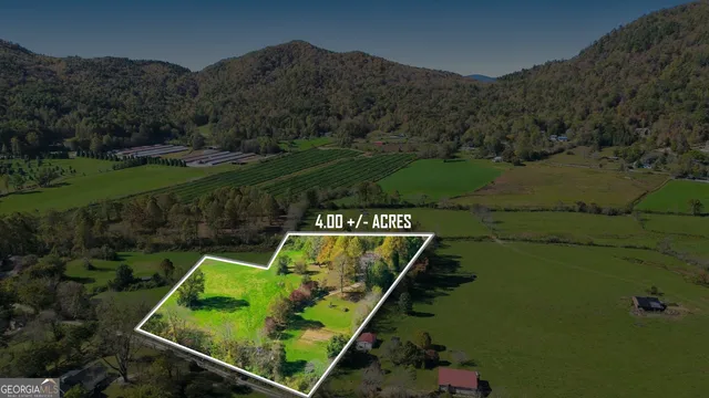 a view of a chair and table in backyard of the house