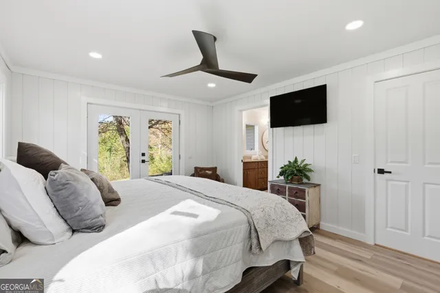 a bedroom with a large bed and a flat screen tv