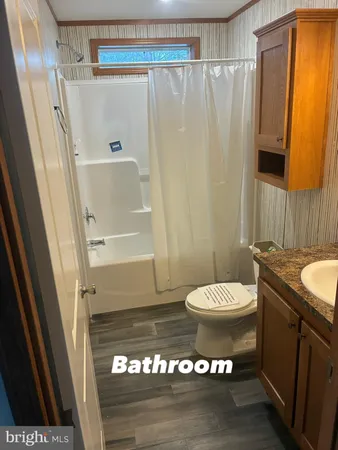 a bathroom with a toilet a sink and a shower