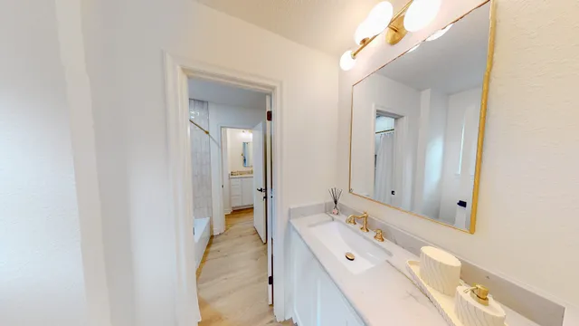 a bathroom with a double vanity sink and mirror