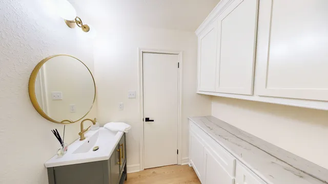 a bathroom with a sink a vanity and a mirror