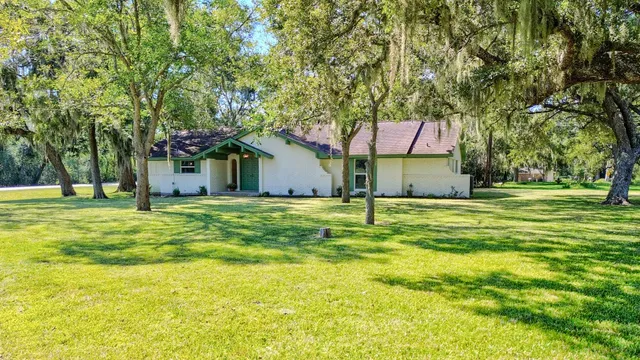 a house with swimming pool in front of it