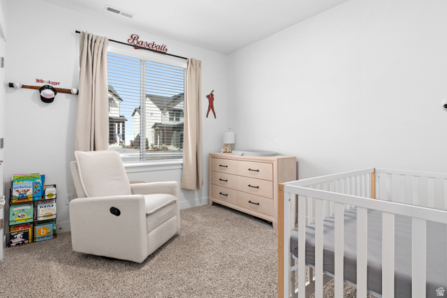 4735 Alder Drive, Unit F101 Mapleton, UT 84664 - Photo 20 of 30 Bedroom featuring a crib and light carpet