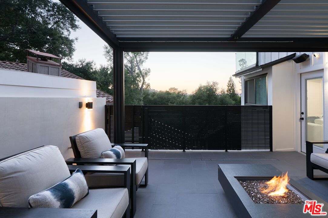 4118 Oak Hollow Road Calabasas, CA 91302 - Photo 31 of 55 a balcony with furniture and a potted plant