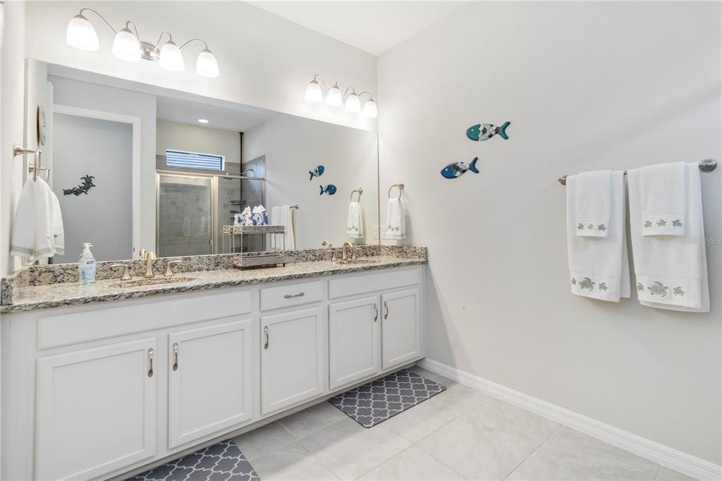 20765 Swallowtail Court Venice, FL 34293 - Photo 18 of 50 a bathroom with a granite countertop sink and a mirror