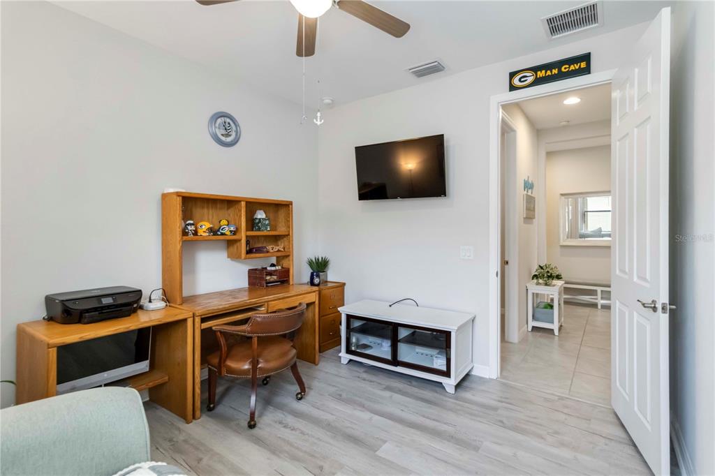 20765 Swallowtail Court Venice, FL 34293 - Photo 25 of 50 a view of a workspace with furniture and a flat screen tv