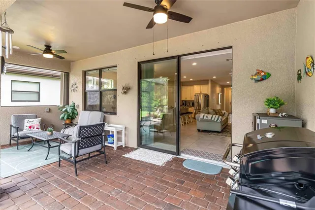 a view of a patio with a table chairs and a backyard