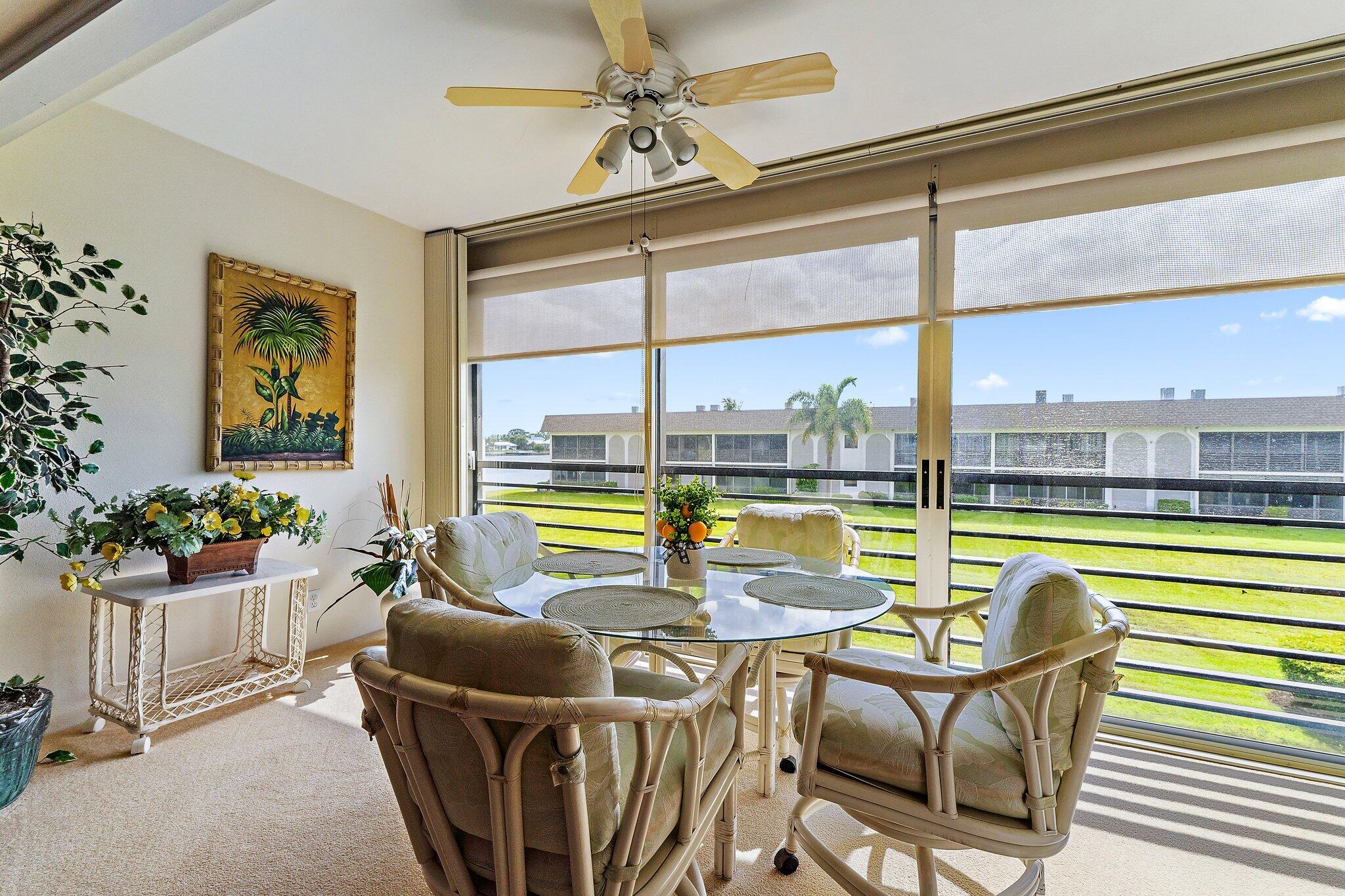 755 Saturn Street, Unit I 206 Jupiter, FL 33477 - Photo 1 of 26 a living room with furniture and floor to ceiling windows