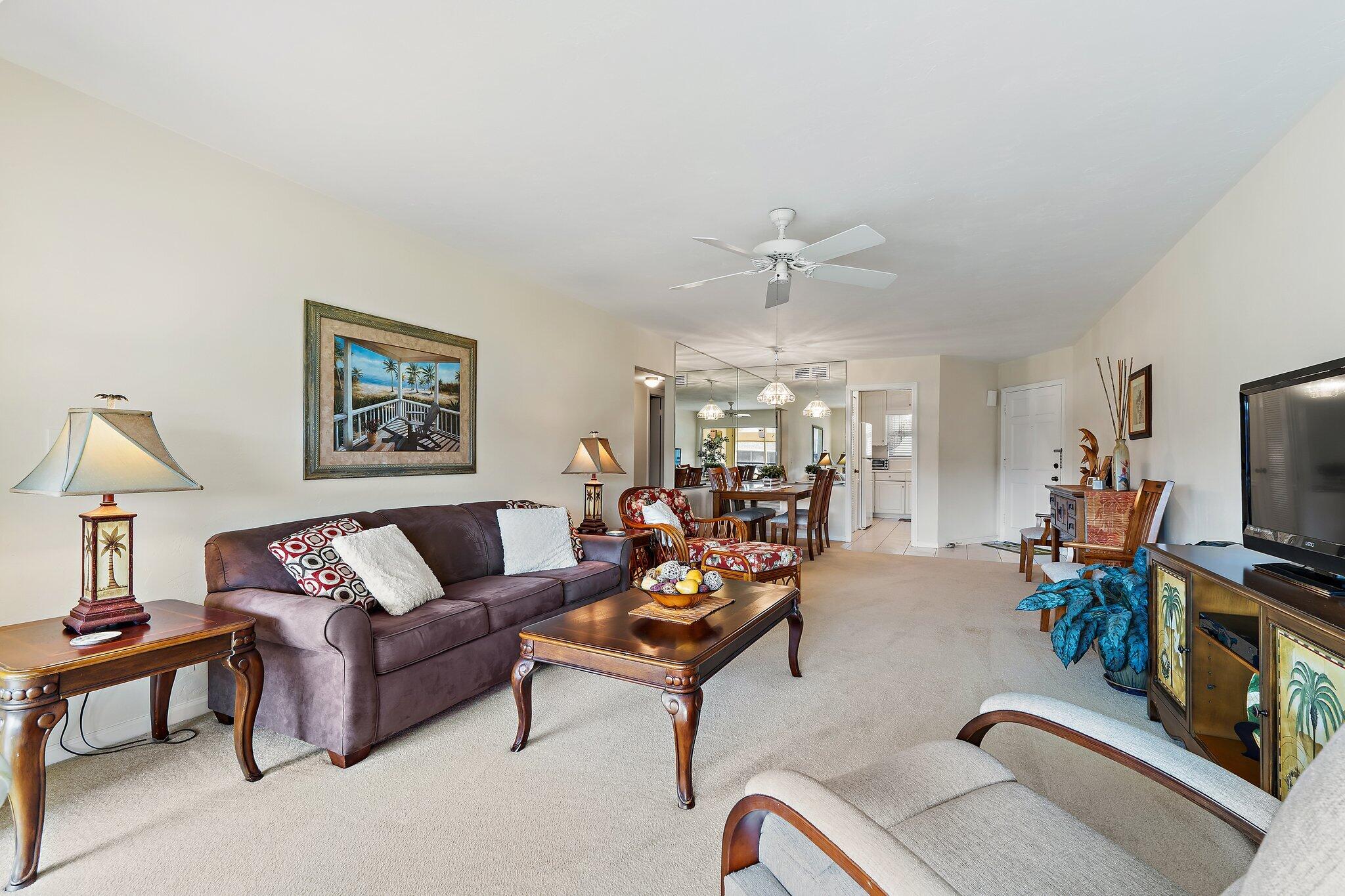 755 Saturn Street, Unit I 206 Jupiter, FL 33477 - Photo 13 of 26 a living room with furniture and a flat screen tv