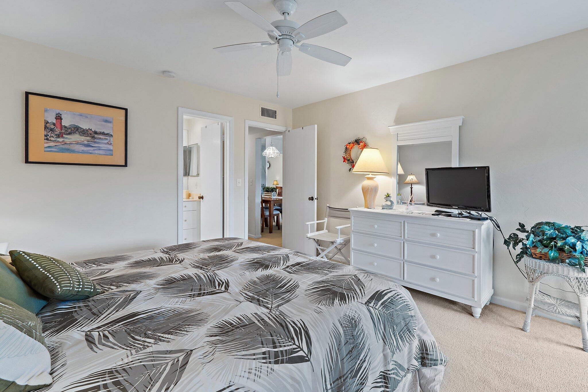 755 Saturn Street, Unit I 206 Jupiter, FL 33477 - Photo 19 of 26 a bedroom with a bed and a computer on the dresser