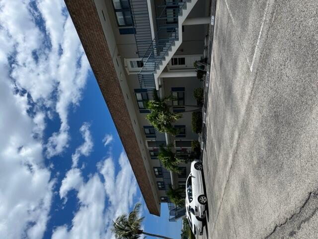 755 Saturn Street, Unit I 206 Jupiter, FL 33477 - Photo 2 of 26 a view of a car park in front of house