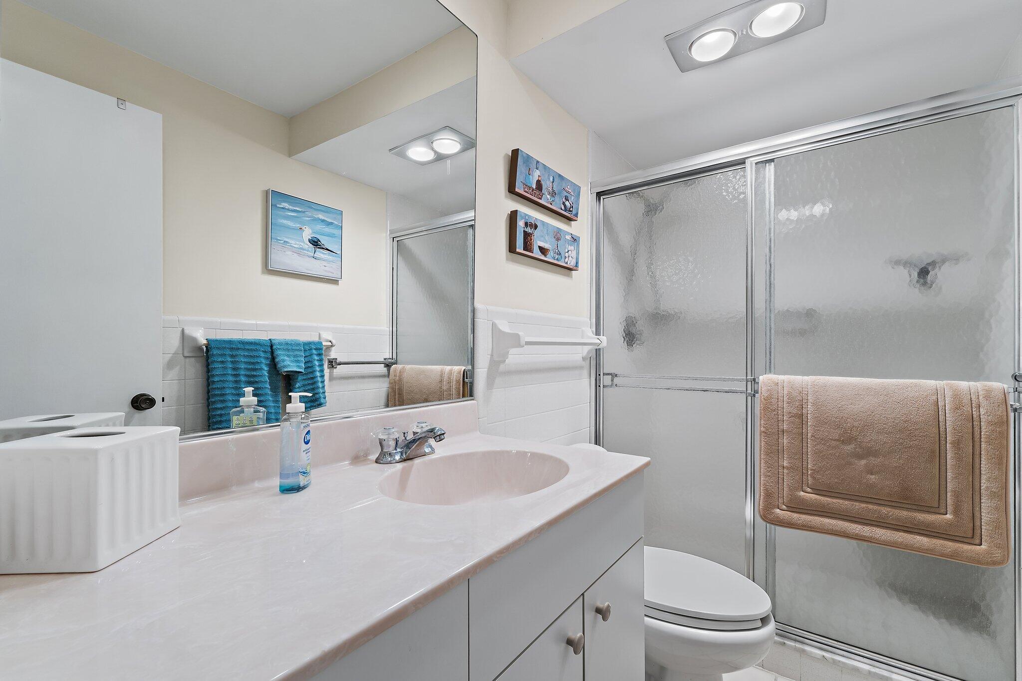 755 Saturn Street, Unit I 206 Jupiter, FL 33477 - Photo 23 of 26 a bathroom with a sink toilet and shower