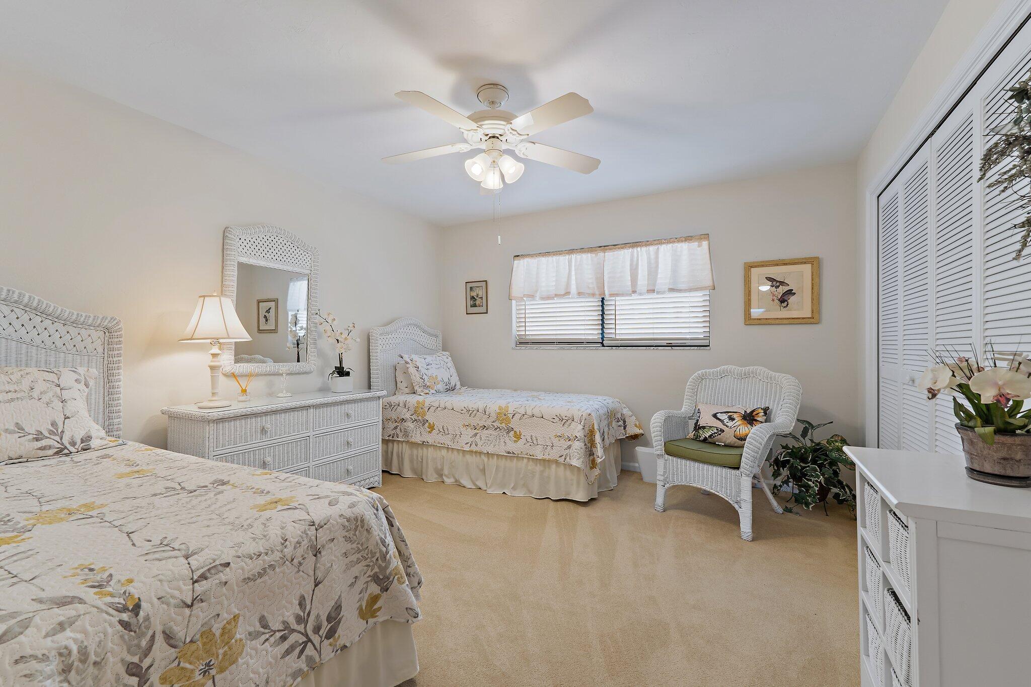 755 Saturn Street, Unit I 206 Jupiter, FL 33477 - Photo 24 of 26 a bedroom with furniture and a chandelier