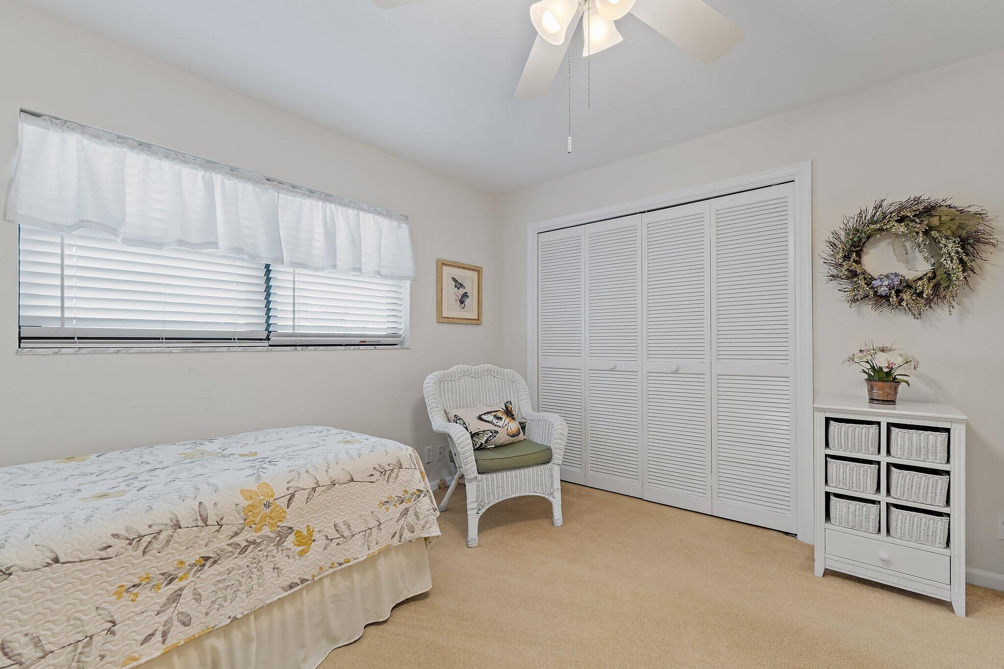 755 Saturn Street, Unit I 206 Jupiter, FL 33477 - Photo 25 of 26 a bedroom with a bed and a window
