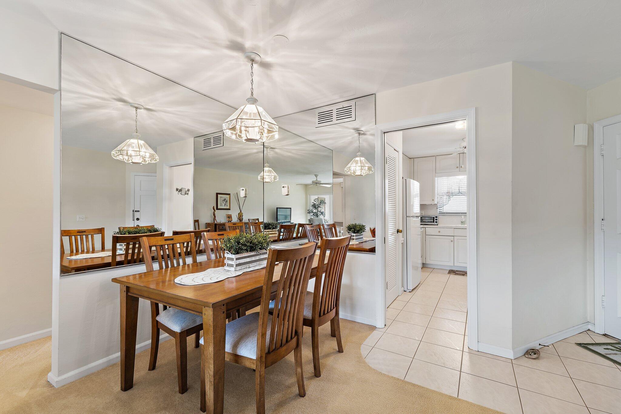 755 Saturn Street, Unit I 206 Jupiter, FL 33477 - Photo 9 of 26 a view of a a dining room and livingroom with furniture a chandelier and wooden floor